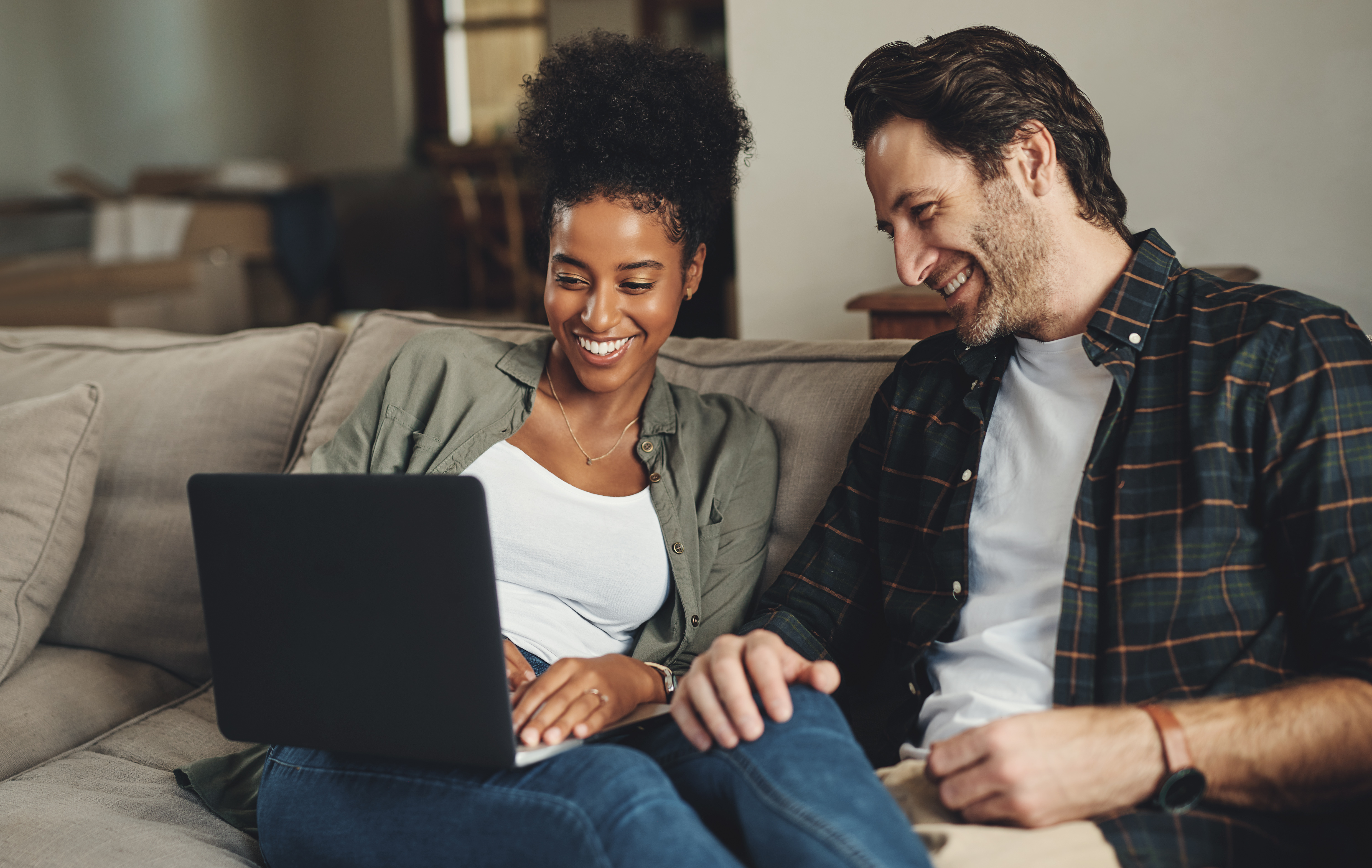 young couple checks out the great deposit account rates online at CACL Financial.
