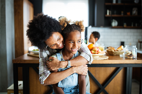 Happy mother and child in the kitchen.